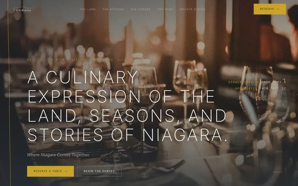 Terrain concept homepage, thin uppercase serif headline over golden-hour glassware